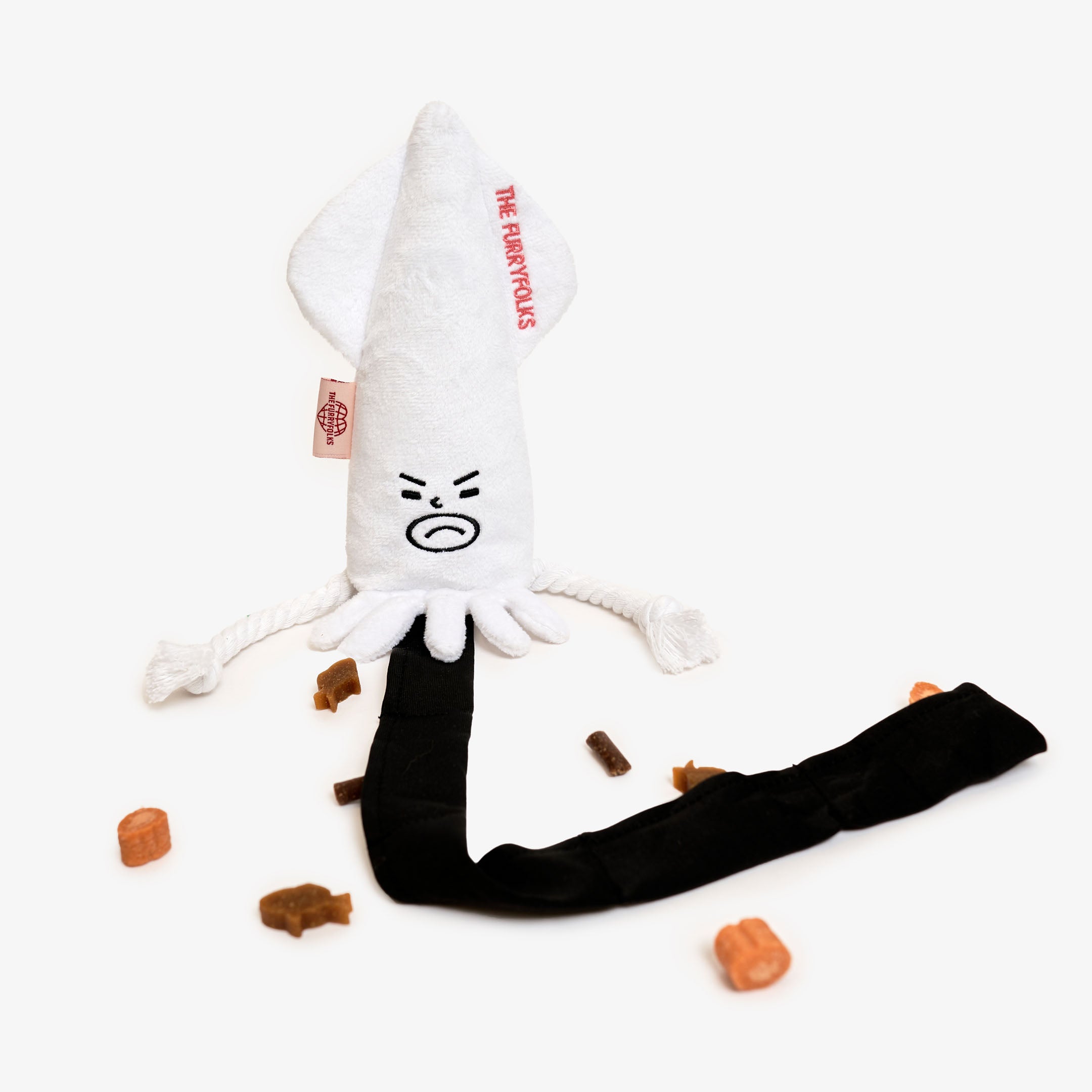 White squid plush dog toy with 'The Furryfolks' branding surrounded by treats.