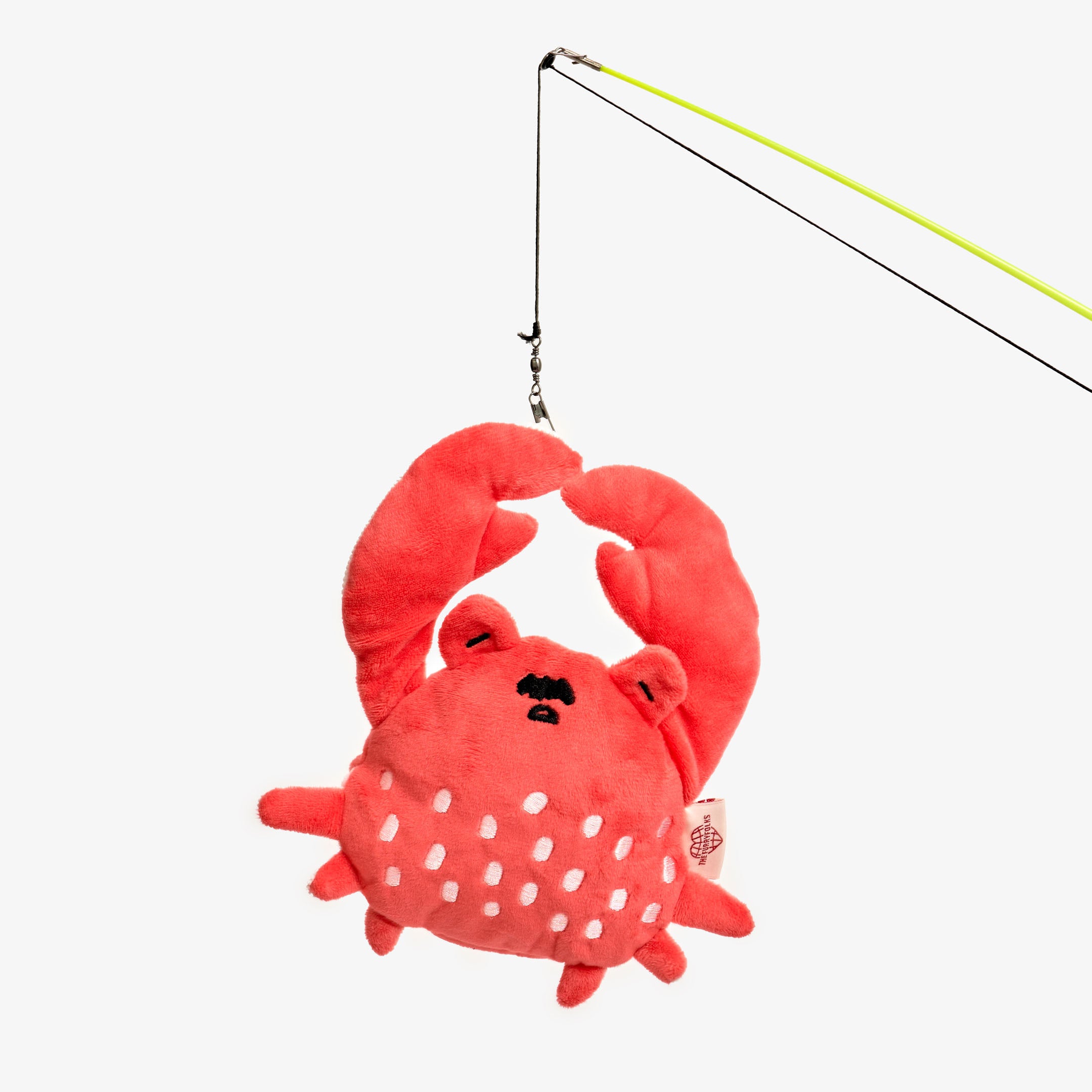 The image features a plush toy resembling a stylized red crab, complete with eyes and spots on its body, suspended from a fishing rod line. The rod, with its lime green handle extending out of the frame, and the way the toy is dangling from the line, suggest that this might be a pet toy designed to simulate fishing, likely for a cat. The playful design and bright color are characteristic of pet toys that are made to attract and engage a pet's attention through movement and visual interest.