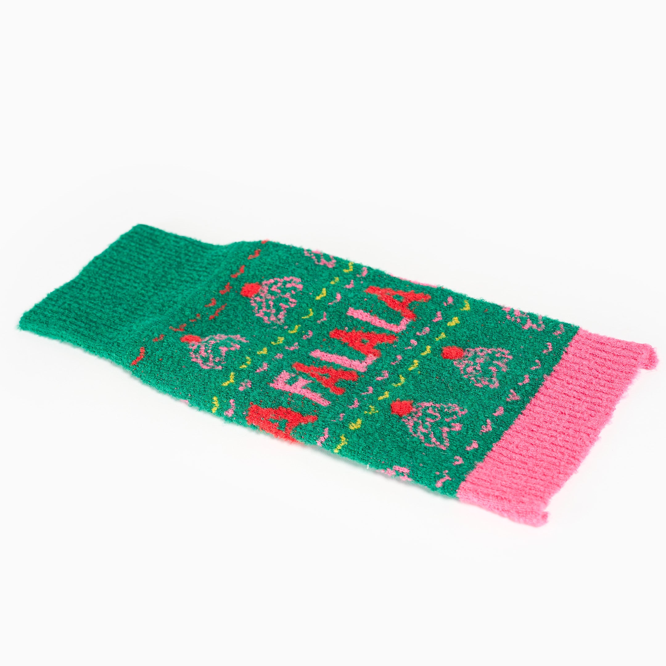 Green and pink knitted dog sweater with 'A falala' text on a white background