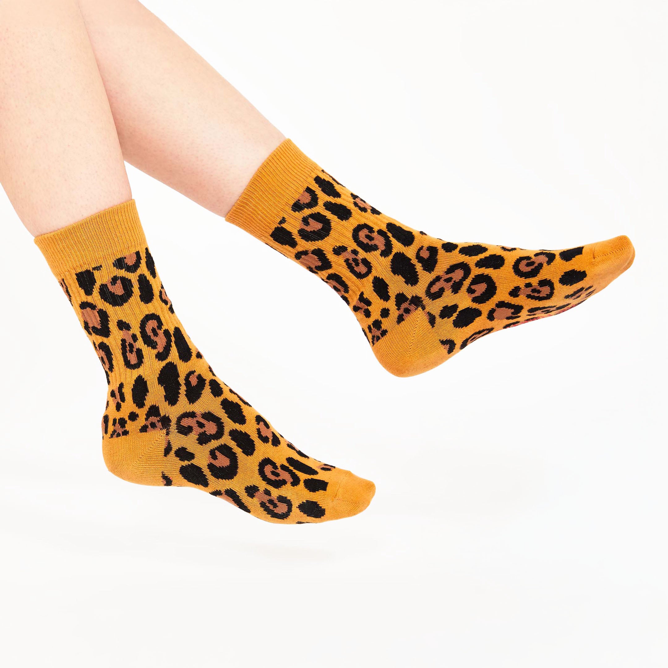 A vibrant pair of mustard-yellow socks adorned with bold leopard print patterns. These eye-catching socks add a wild, fun twist to any outfit, perfect for those who love to stand out in style!