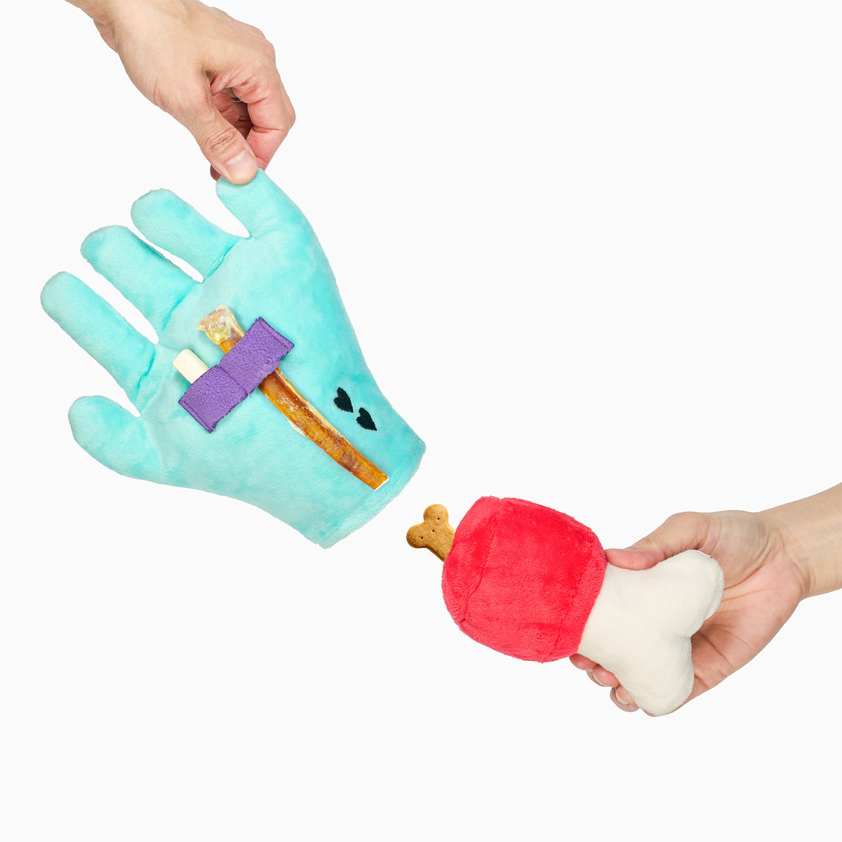 Lost Hand dog toy separated into hand and bone pieces, showing treats beneath the purple palm straps and in the bone pocket.