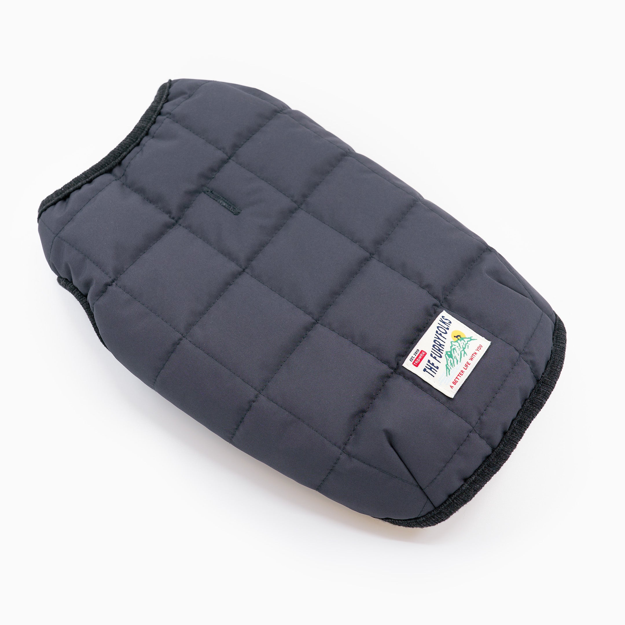 Gray quilted dog coat with a brand label on a white background