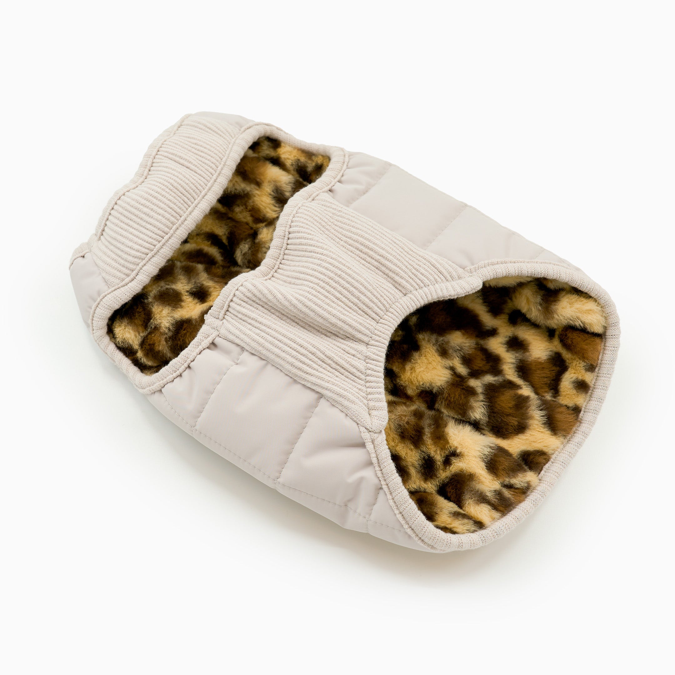 Beige slipper with leopard print interior on a white background