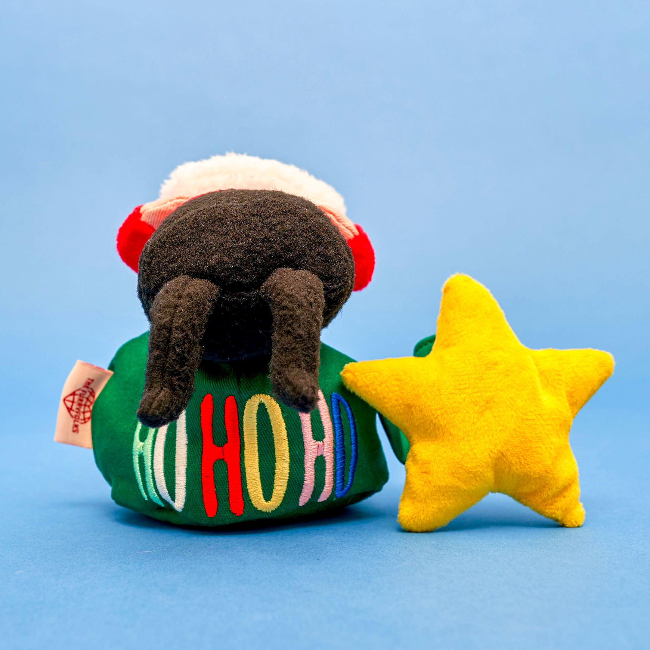 A colorful and interactive holiday toy for dogs, featuring Santa Paws and festive decorations.