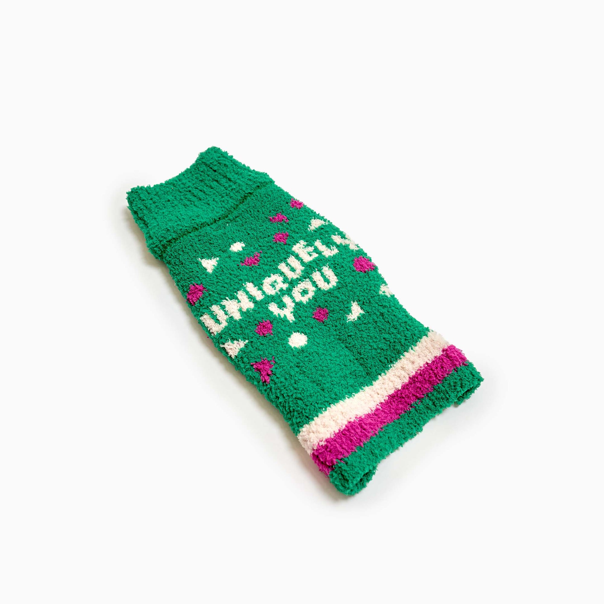 A vibrant green dog sweater with "Uniquely You" text and heart motifs, perfect for a pet's personalized fashion statement.