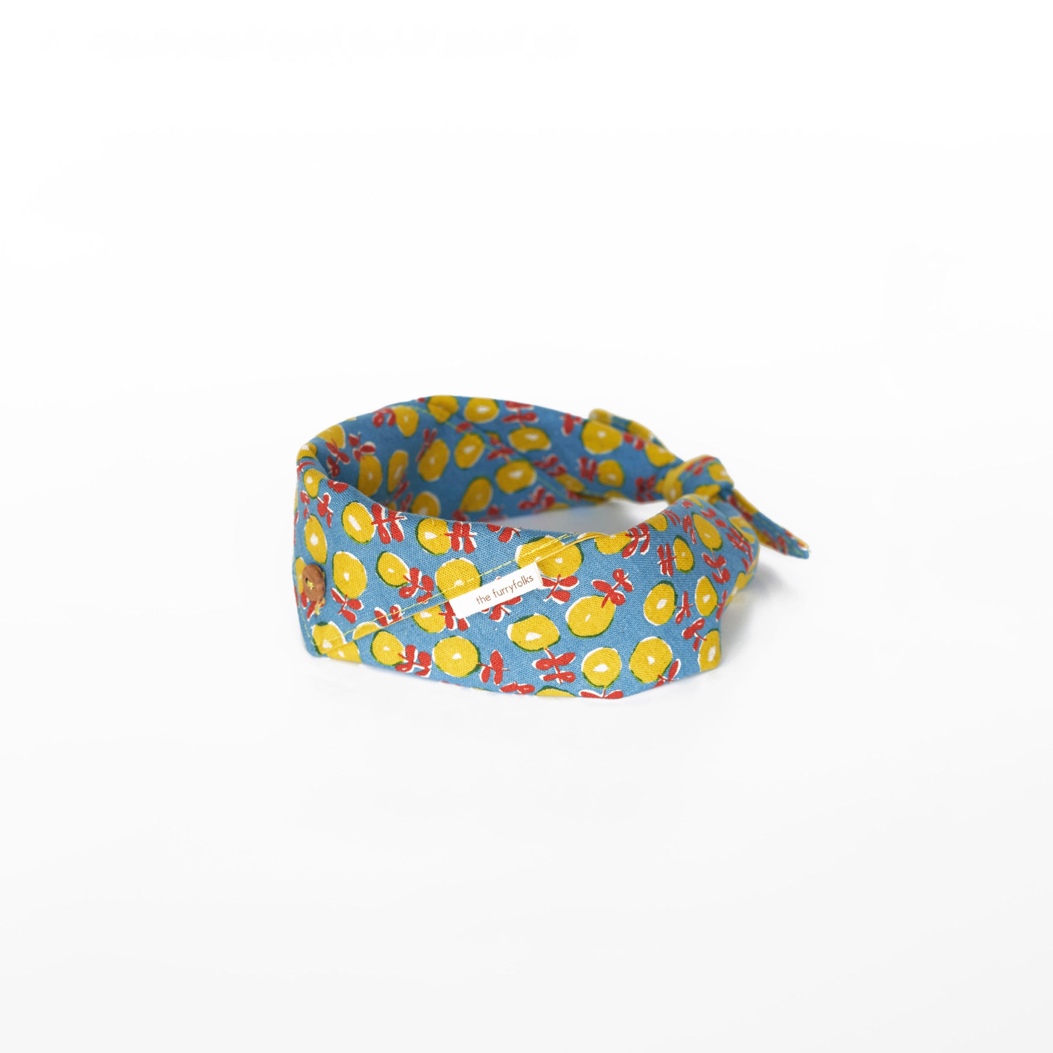 Colorful dog bandana with a playful flower pattern by The Furryfolks.