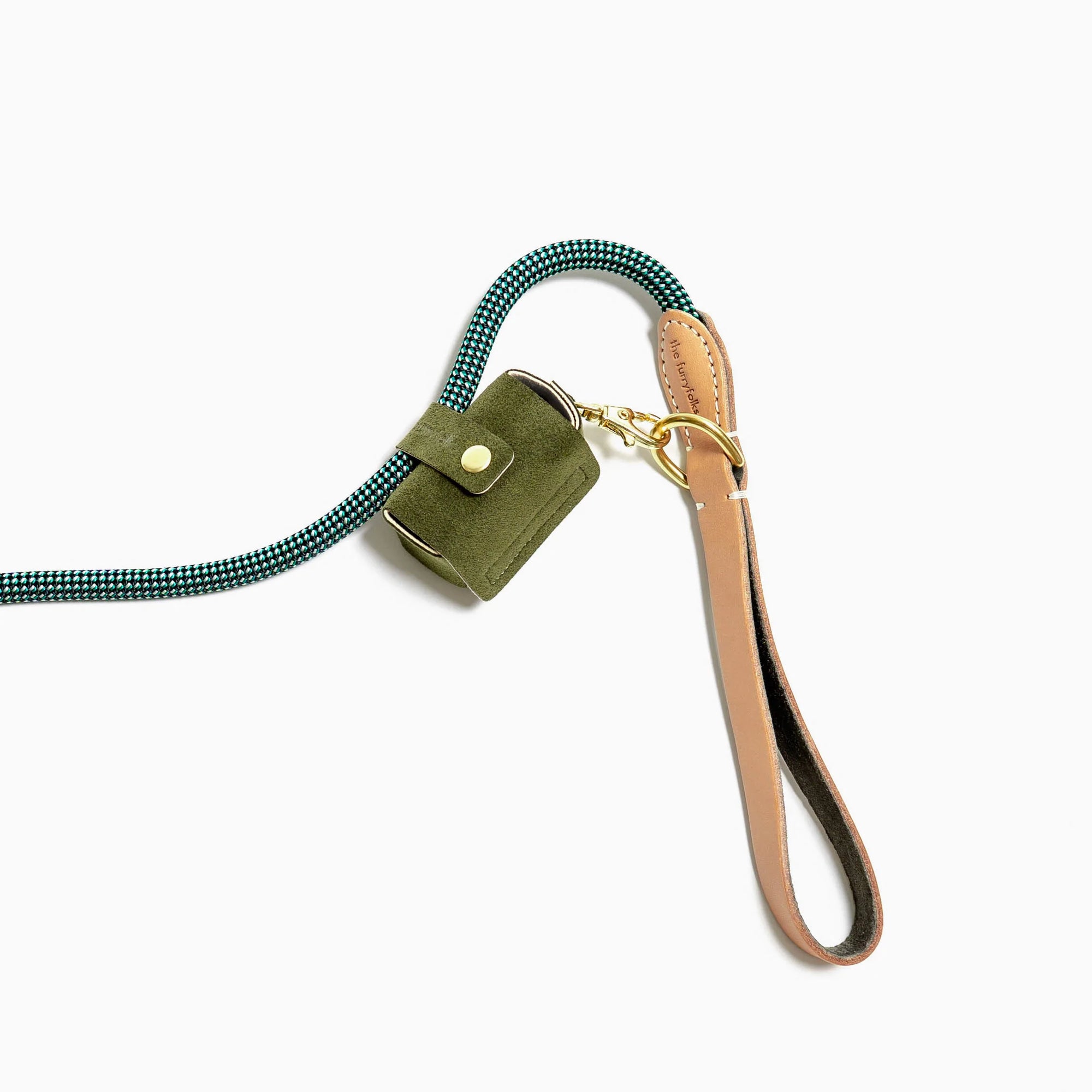 a dog leash with a green fabric poop bag holder attached to it. The holder, which matches the ones previously shown, is affixed to the leash via a golden clip, demonstrating its practical use. It is accompanied by a leather strap, adding an element of style to the functionality. The poop bag holder's design ensures that dog walkers can conveniently carry bags for cleaning up after their pets, illustrating the product in use. 
