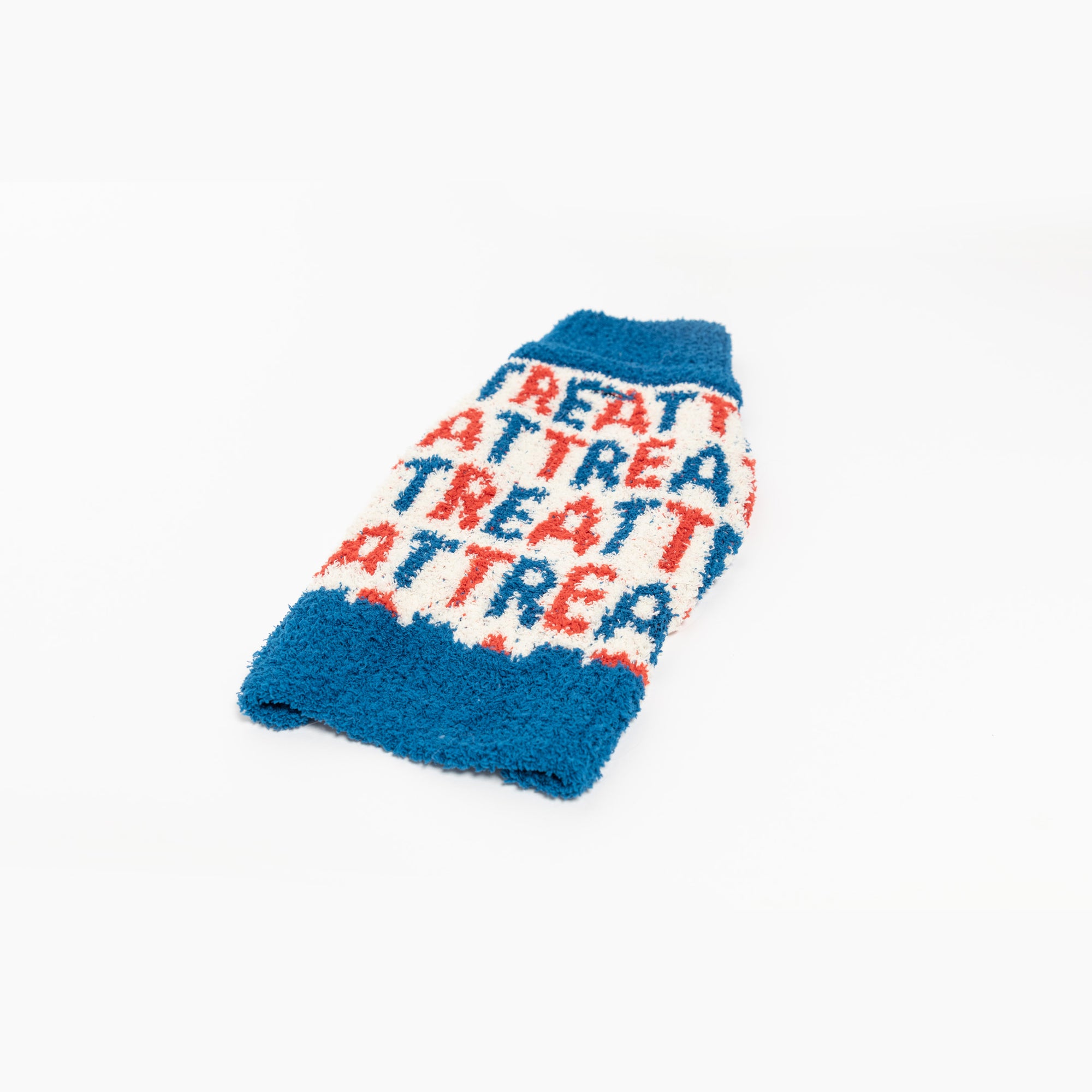  A vibrant blue dog sweater with a playful "Treat" pattern, designed to keep your furry friend warm and stylish.